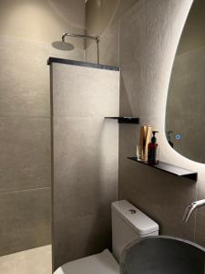 a bathroom with a toilet and a sink and a mirror at Mellow Paros in Parikia