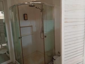 a shower with a glass door in a bathroom at Four Palms Guest House in Praia +37 photos
