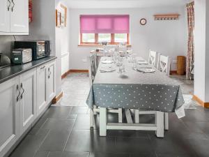a kitchen with a table with a polka dot table cloth at Stocks Tree Cottage in Preston Wynne