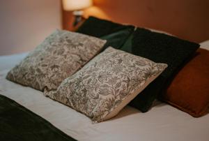 a bed with two pillows on top of it at Villa de Meslay in Montaigu-Vendée +15 photos
