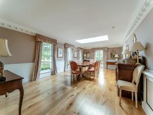 a dining room with a table and chairs at Kilmichael House in Brodick