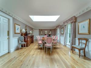 a dining room with a table and chairs at Kilmichael House in Brodick