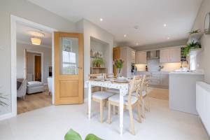 a kitchen and dining room with a table and chairs at Coolbuck Cottage in Lisbellaw