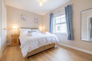 a bedroom with a bed and a window at Coolbuck Cottage in Lisbellaw