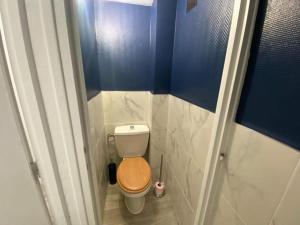 a small bathroom with a toilet with a wooden seat at L'Apart Amiens in Le Treuil
