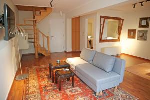 a living room with a couch and a rug at Anavyssos Riviera Cozy Bee Home Maisonette in Anavyssos