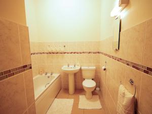 a bathroom with a toilet and a sink at Plough Cottage in Anderby