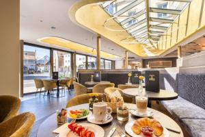 a restaurant with a table with food on it at Hotel Schlosskrone in Füssen