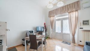 a dining room with a table and a window at Casa Alessia by Rentbeat in Cisternino