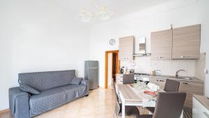 a living room with a couch and a table in a kitchen at Casa Alessia by Rentbeat in Cisternino
