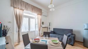 a living room with a table and a couch at Casa Alessia by Rentbeat in Cisternino