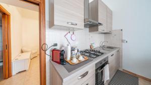 a kitchen with a stove and a counter top at Casa Alessia by Rentbeat in Cisternino +12 photos