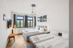 a living room with two beds and a couch at Arbio I Modern Apart near Leipzig Stötteritz in Leipzig +7 photos