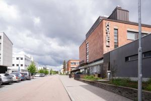an empty street in a city with buildings at Omena Hotel Joensuu in Joensuu