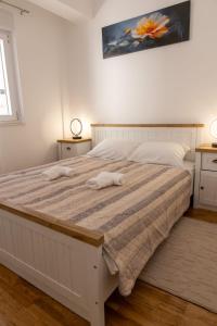 a bedroom with a white bed with two towels on it at Apartment LANA in Čapljina
