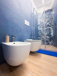 a bathroom with a large white tub and a shower at La Chicca di Ameli in San Severo +18 photos