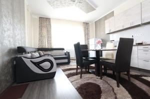 a kitchen and dining room with a table and chairs at Centrum Apartman in Nagykálló