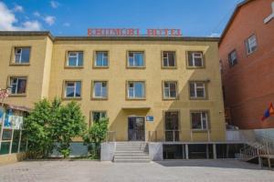 a building with a sign on the front of it at Khiimori Hotel in Ulaanbaatar