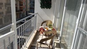 a table and two chairs on a balcony at Krasi Apartments in Perla Complex in Pomorie