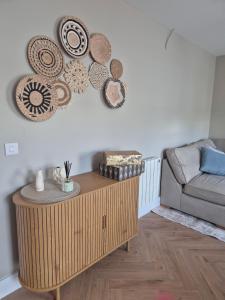 a living room with a couch and plates on the wall at The Ledger Rooms in Gort