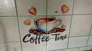 a cup of coffee on a tile with coffee beans at Apartments Krn in Drežniške Ravne +30 photos