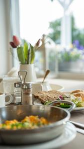 a table with a plate of food on a counter at Biały Dom Henlex Hotel Restauracja in Poznań
