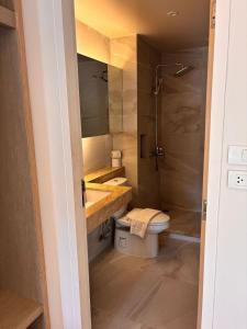 a bathroom with a sink and a toilet and a shower at Breezy Studio Aonang in Ao Nang Beach