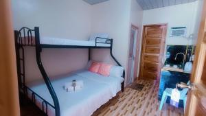 a bedroom with two bunk beds in a room at Victoria's Inn in Siquijor