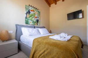 a bedroom with a bed with a towel on it at IseoLakeRental - Casa Lani in Costa Volpino +25 photos