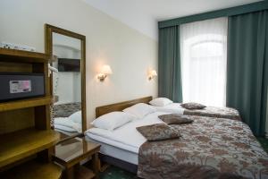 Postel nebo postele na pokoji v ubytování Hotel St. Barbara