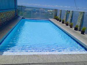 a swimming pool on top of a building at TWD 716 Cityscape in Bacolod