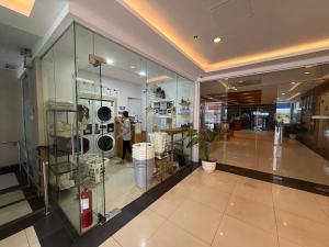 a person taking a picture of a glass case in a building at TWD 716 Cityscape in Bacolod