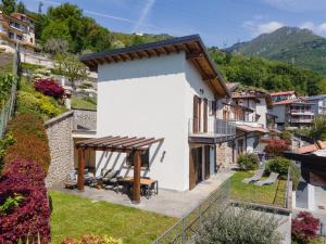 a view of a house with a table and chairs at IseoLakeRental - Casa Cuneo in Costa Volpino