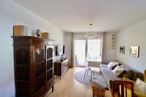 a living room with a couch and a table at Ferienwohnung H 25 "Tausendschön" in Graal-Müritz +4 photos
