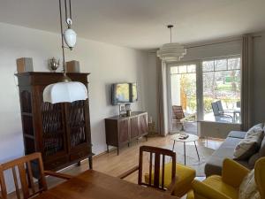 a living room with a couch and a table at Ferienwohnung H 25 "Tausendschön" in Graal-Müritz