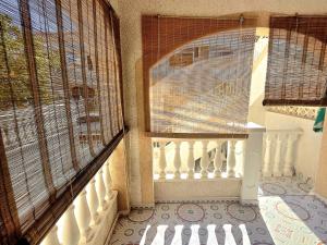 a balcony with a white railing and a window at Bungalow Brisa de Mar in Torrevieja +26 photos