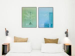 a bedroom with three framed posters on the wall at Apartment Seebrise by Interhome in Lembruch