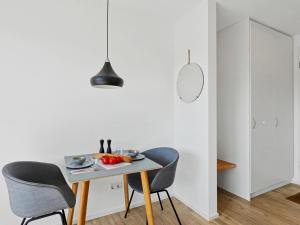 a dining room with a table and two chairs at Apartment Seebrise by Interhome in Lembruch