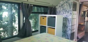 a bedroom with a bed and a window at Bus aménagé in Millas
