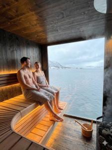 a couple sitting on the deck of a boat at Steam Pier Adventure Hotel in Tromsø +94 photos
