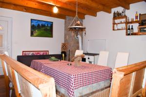 a dining room with a table with a red and white checkered table cloth at Konoba Oklop in Tomislavgrad