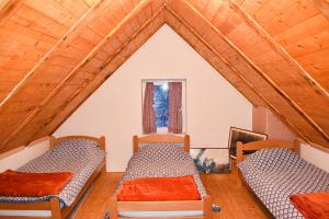 a room with two beds and a window at Konoba Oklop in Tomislavgrad
