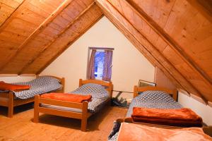 a room with three beds in a attic at Konoba Oklop in Tomislavgrad +20 photos