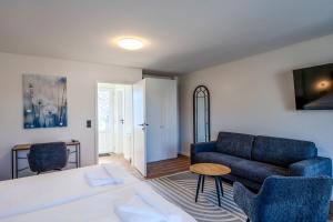 a living room with a couch and a table at Johouse Zingst Johouse Zimmer 21 in Zingst