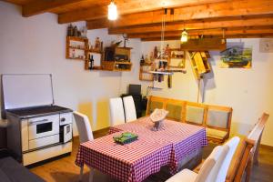 a kitchen with a table and a stove in a room at Konoba Oklop in Tomislavgrad