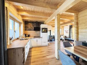 a kitchen and living room in a log cabin at Chalet Nockhütte by Interhome in Hochrindl
