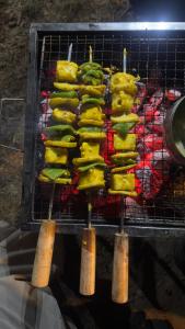 a grill with a bunch of food on at Tent-It India Experiences in Mukteshwar