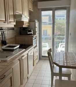 a kitchen with a table and a table and a dining room at Apartment in Chessy very near Disneyland in Chessy