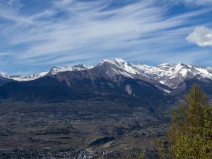 a mountain range with snow capped mountains in the background at Chalet Chalet Le Trèfle by Interhome in Salins
