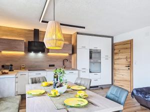 a kitchen and dining room with a table and chairs at Apartment Schöser by Interhome in Weerberg